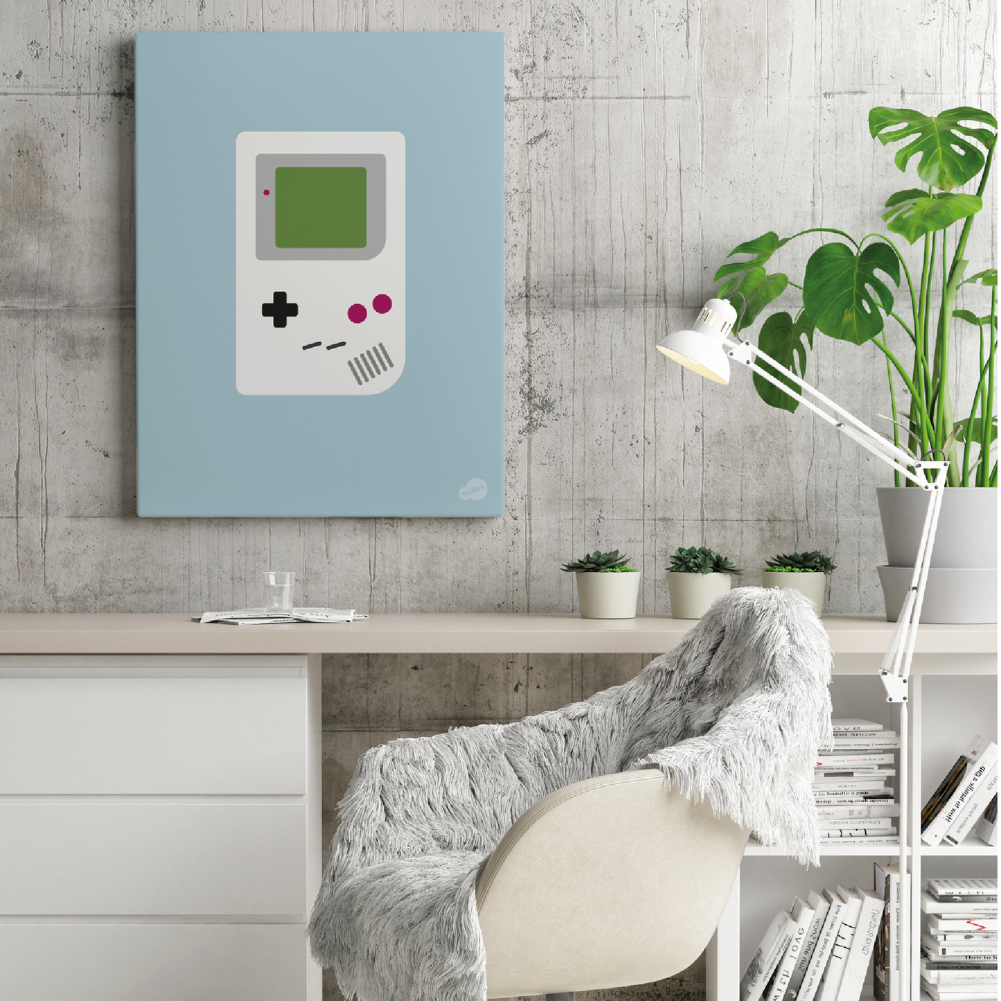 Blå retro plakat med klassisk Game Boy-motiv hengende på en vegg over et skrivebord